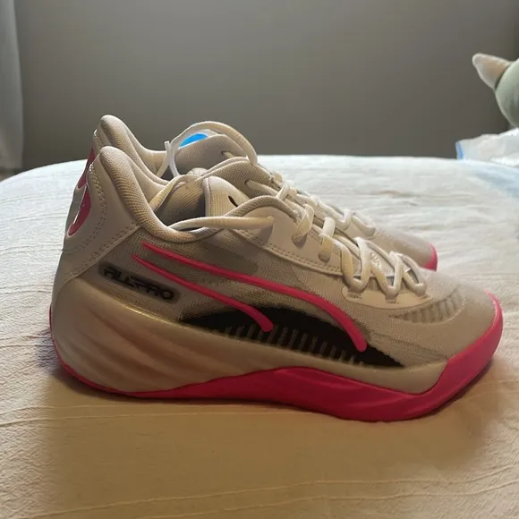 Pink, White, and black Puma basketball shoes. Size 4 in kids.