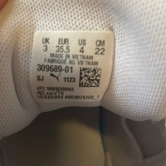 Pink, White, and black Puma basketball shoes. Size 4 in kids.