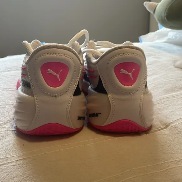 Pink, White, and black Puma basketball shoes. Size 4 in kids.